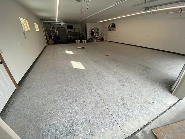 Worn concrete garage floor before polyurea coating