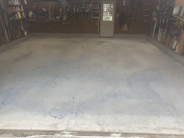 Cracked bare concrete garage floor before Panther Coatings installation