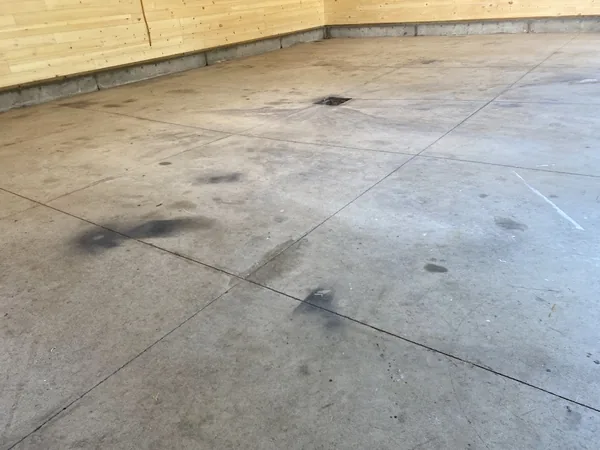 Old stained garage concrete before coating
