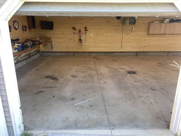 Cracked bare concrete garage floor before Panther Coatings installation