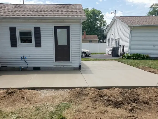 Pool deck with stained weathered concrete before resurfacing