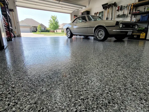 Classic Camaro on dark flake garage floor coating by Panther Coatings