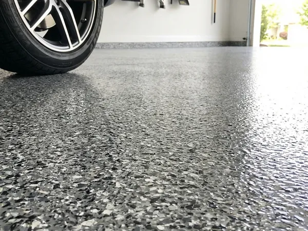 Close-up of black and white flake garage floor coating by Panther Coatings