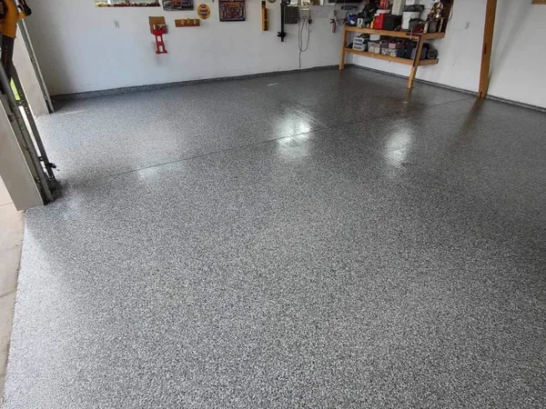 Finished gray flake garage floor wide interior view by Panther Coatings
