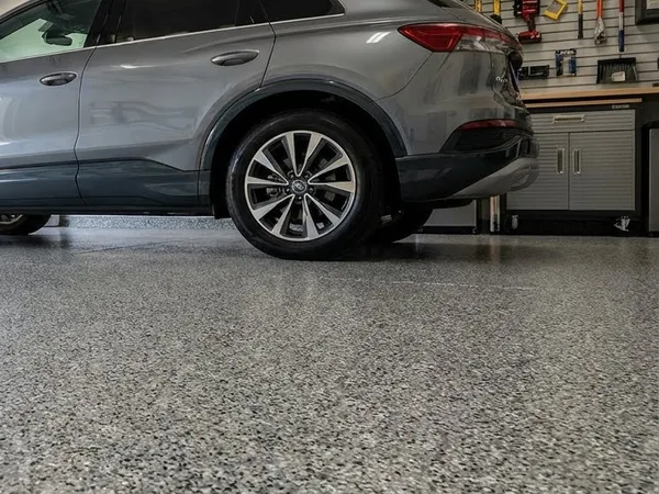 SUV parked on gray flake garage floor coating by Panther Coatings