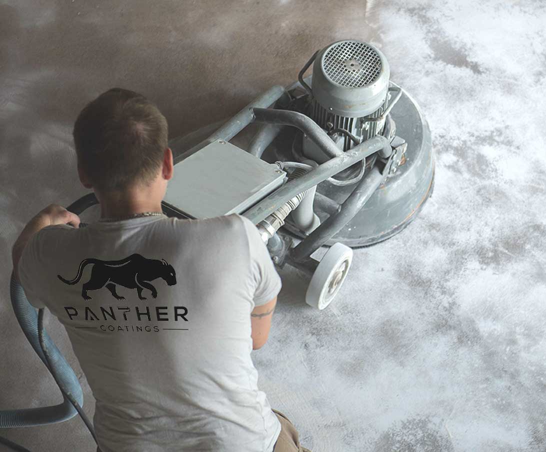 Panther coating employee grinding concrete floor before concrete coating system gets applied.